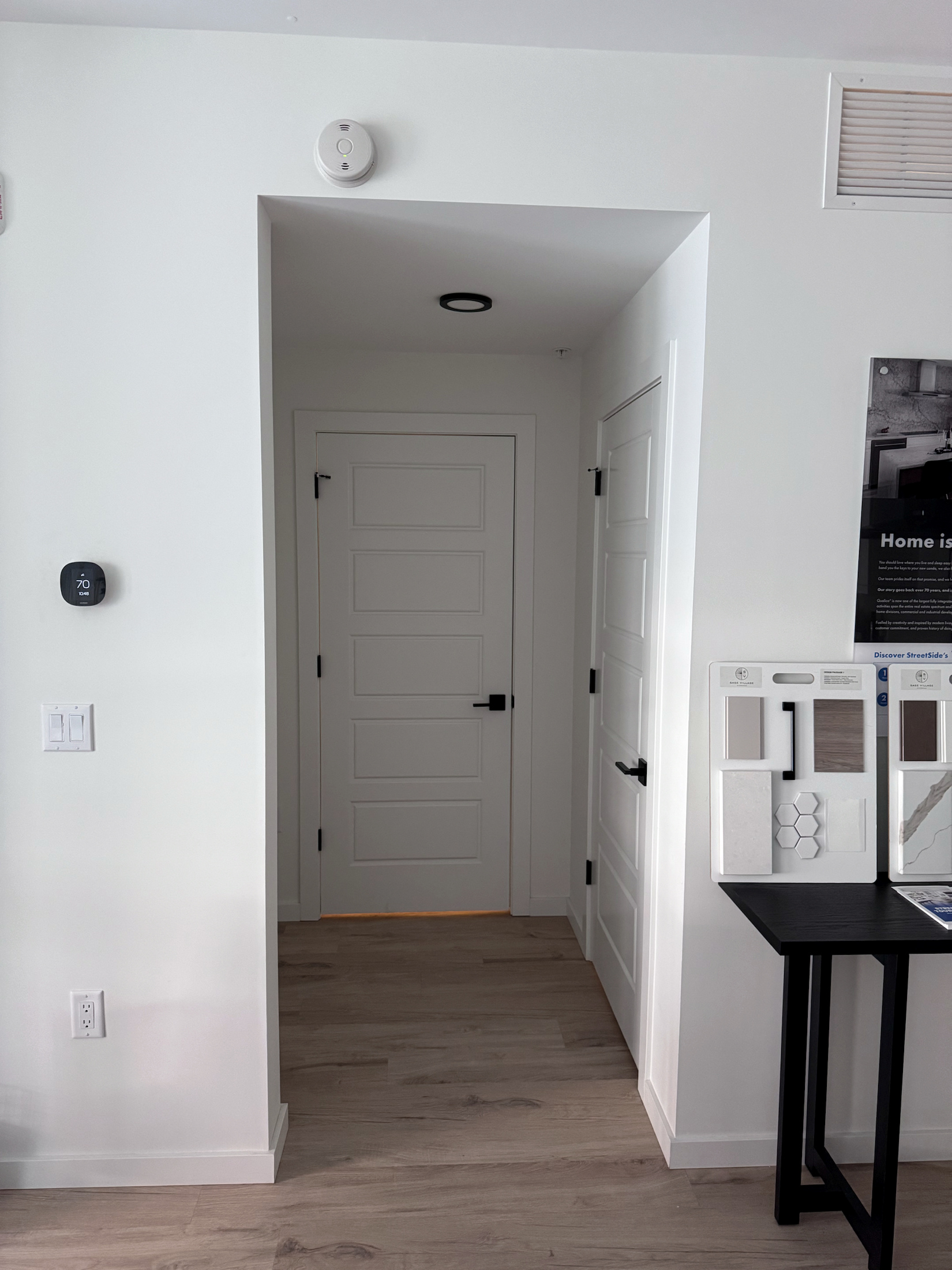 White panel door with finished casing and black hardware