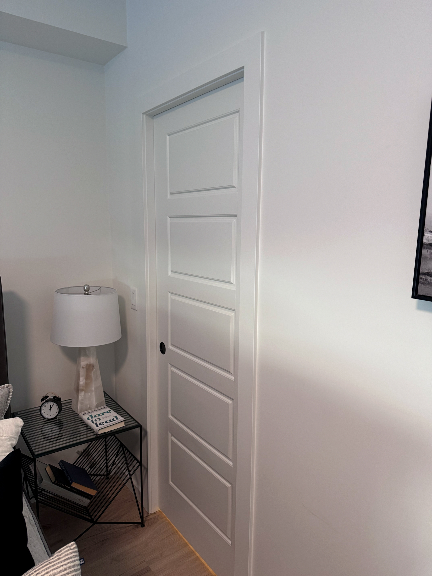 White five-panel pocket door with matching casing